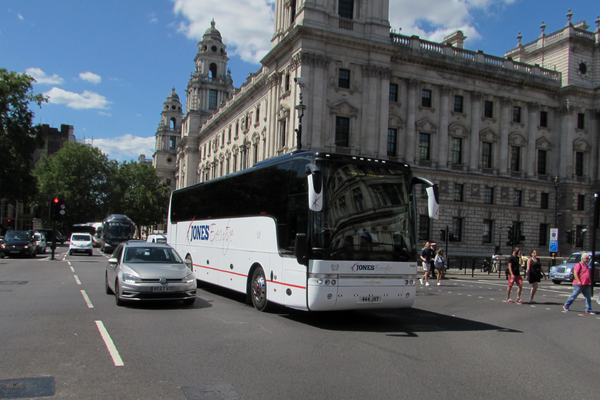 sports team coach hire. Coach travelling through a city centre